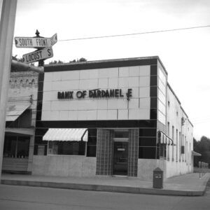 Multistory concrete building with sign saying "Bank of Dardanelle" with the second letter L in Dardanelle hanging