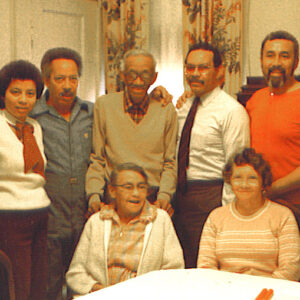Nine African Americans gathered around a table