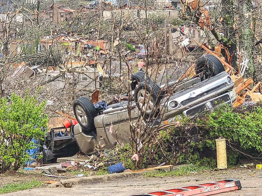 Scene of debris with vehicle upside down