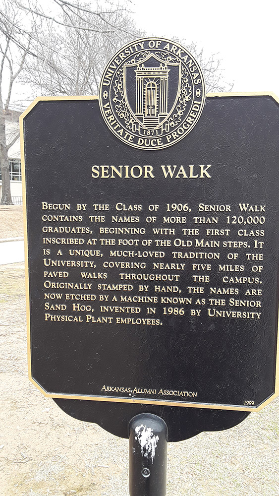 Metal plaque on pole "Senior Walk"