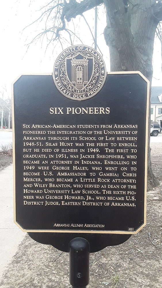 Metal sign on pole "Six Pioneers"