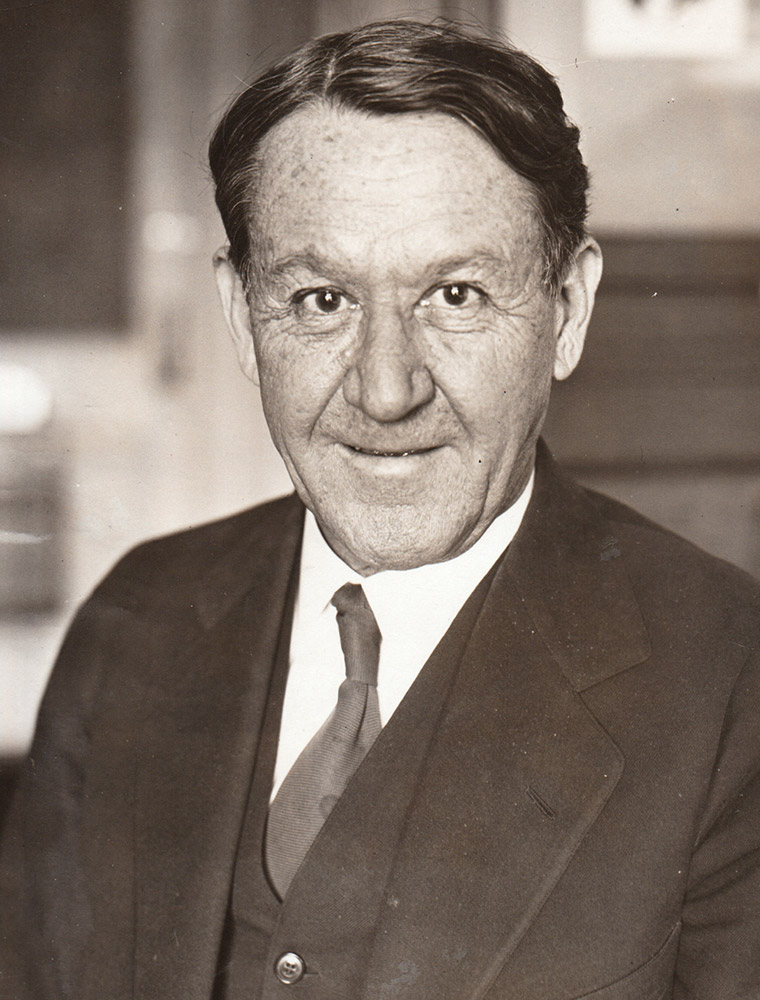 Head and shoulders shot of white man in suit and tie