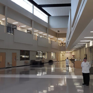 Large interior space with people wearing chef uniforms