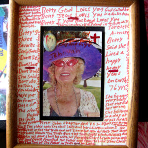 Photo of elderly woman in pink glasses and purple hat surrounded by red handwritten text