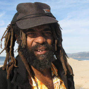 Bearded African American man with dreadlocks and cap