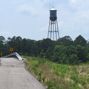 Silver water tower with "Ola" printed on it