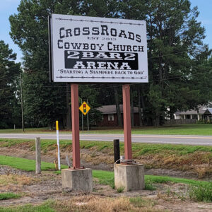 Sign "Crossroads Cowboy Church" with road