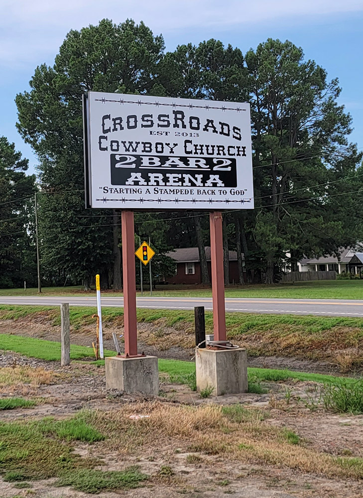 Sign "Crossroads Cowboy Church" with road