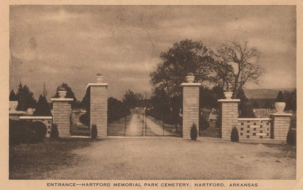 Metal gate with brick pillars flanking it