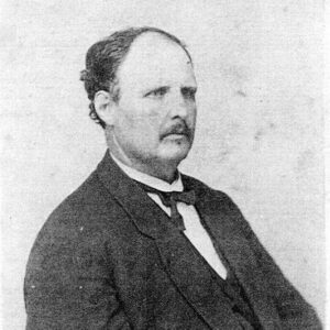 White man with mustache in suit and cravat