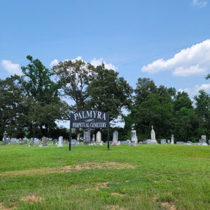 Large grassy area with gravestones and trees