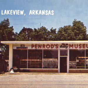 Single story white building with large windows with sign saying "Penrod's Hobby Museum"