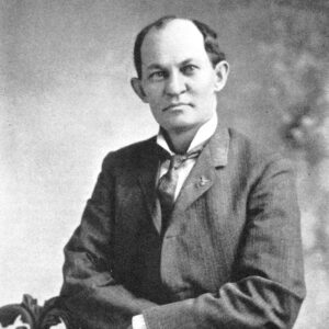 Partially bald white man wearing suit and tie