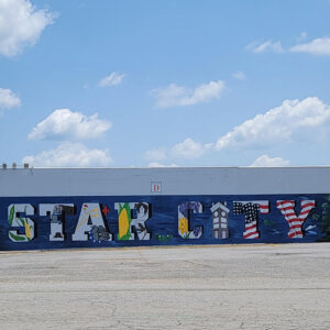 Large mural painted on side of building saying "Star City" and showing corn
