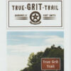 Paper flyer advertising "True Grit Trail" with photograph depicting roadside and sign