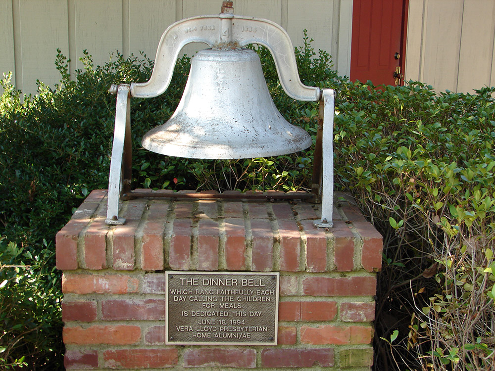 Large metal bell with plaque saying "The Dinner Bell"