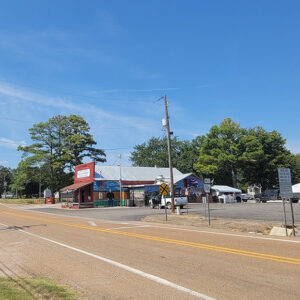 Small town street scene with country store and railroad crossing