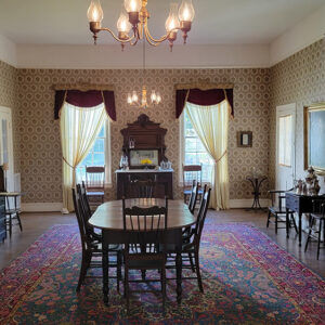 Wallpapered room with antique dining room furnishings