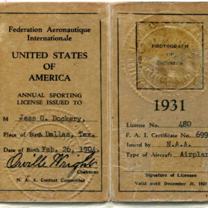 A yellow two-page booklet of the pilot license issued to Jess O. Dockery