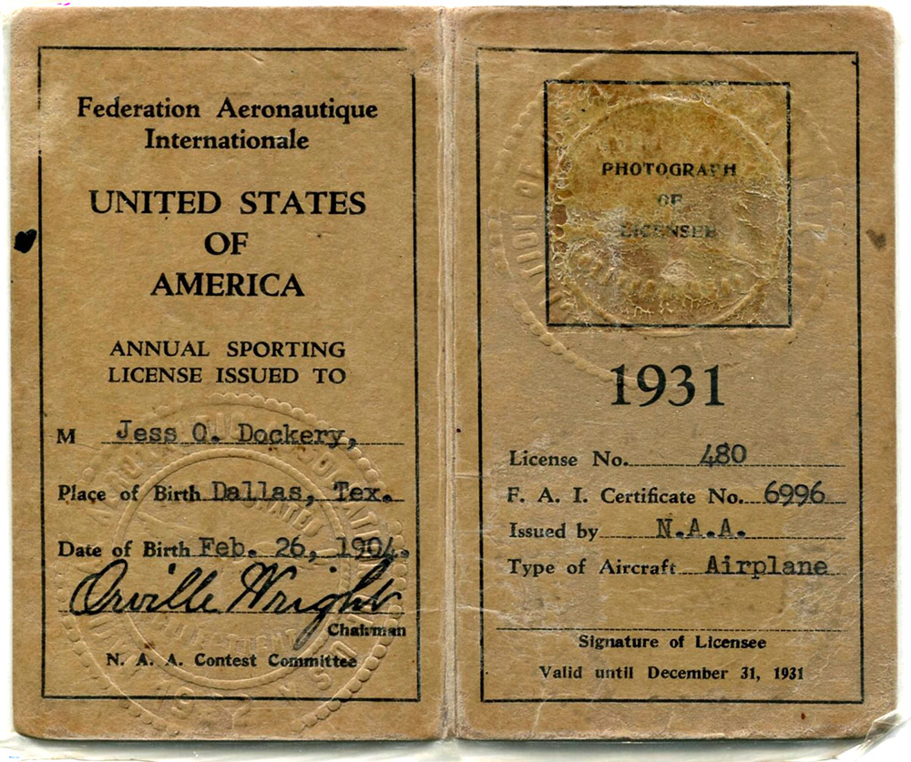A yellow two-page booklet of the pilot license issued to Jess O. Dockery