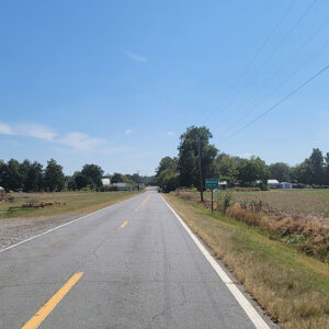Entering small town on a country road next to a field and a sign saying "Widener"