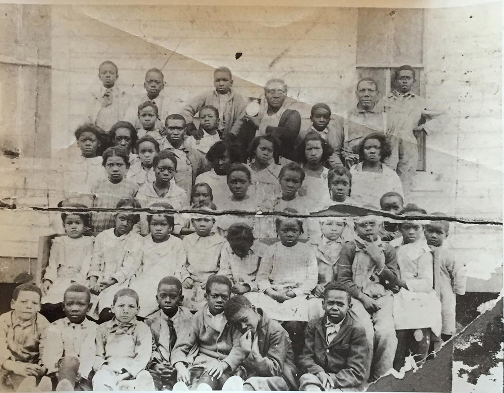 Large group of dressed up African American youths posing for group portrait