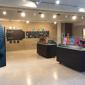 Museum exhibit of rock music items displayed on the wall and in cases
