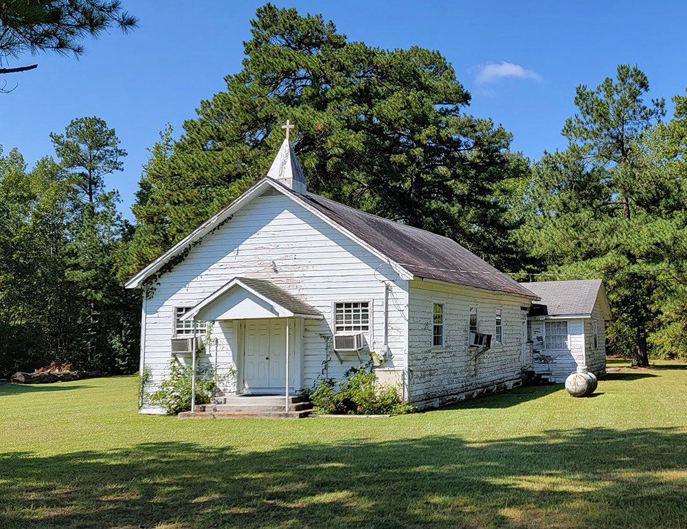 White wooden country church building with steeple