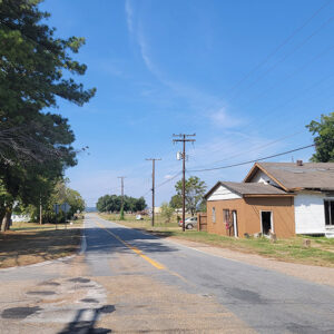 Small town road with dilapidated building