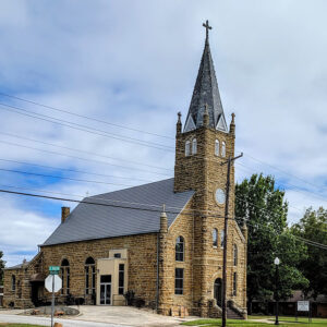 Multistory stone church building with large front-facing tower