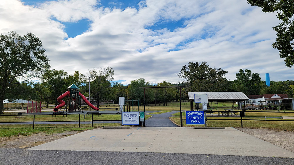 park with playground equipment and pavilions and trees in background
