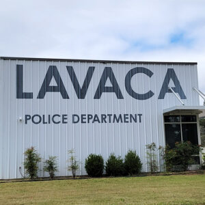Multistory white metal building with "Lavaca Police Department" in large lettering