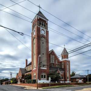 large multistory red brick church building with tall tower