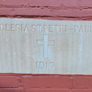 Concrete datestone saying in Latin "Eglesia St. Petri-Paul 1917"