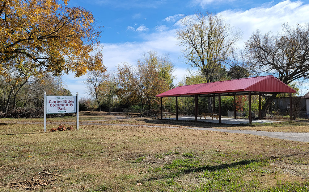 Small park with pavilion and picnic tables and trees