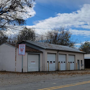 Single story metal building with four garage doors