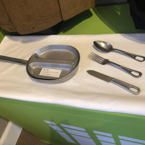 metal plate and cutlery on display in a case