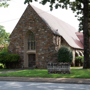 Stone church complex with red slate roof