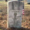 Gravestone "Christian Steiner" with cross engraved on it and flag beside