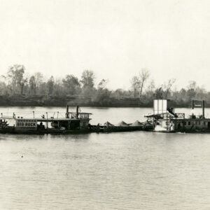 Paddleboat pushing barges on a river
