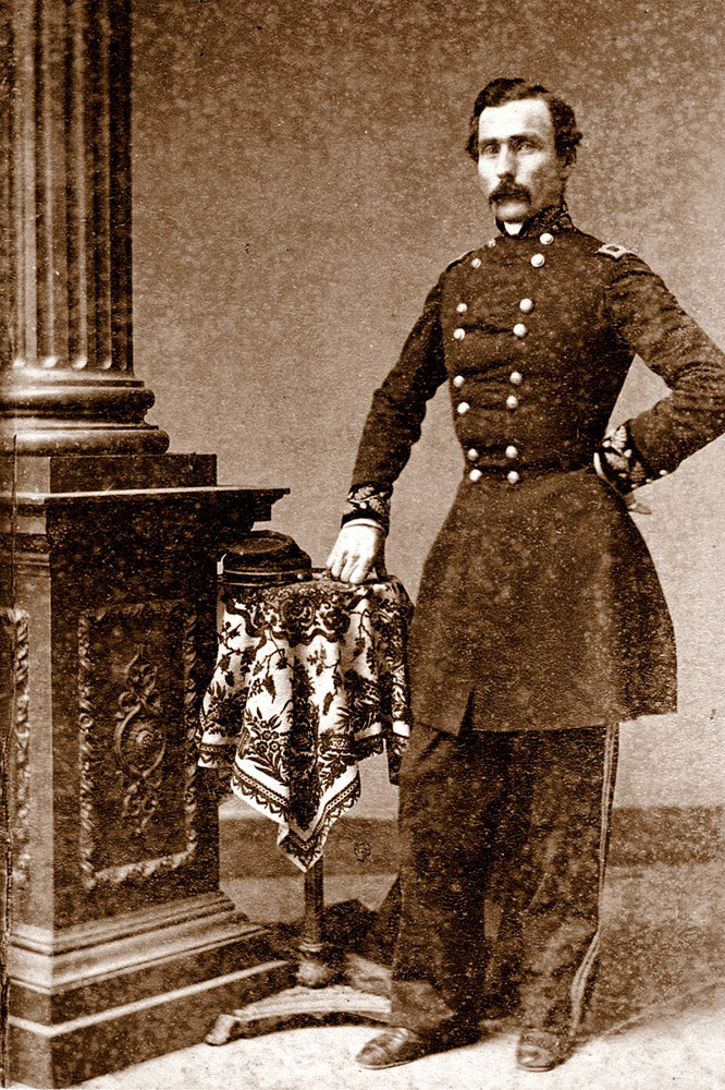 White man in military garb next to column