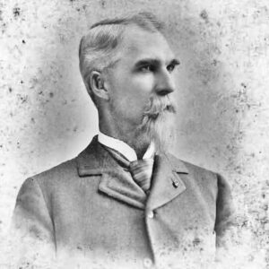 Bearded white man in suit and cravat