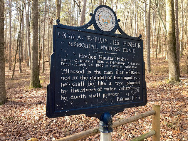 Sign with the great seal of Arkansas and information about a hiking trail
