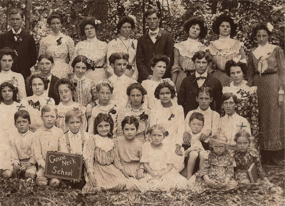 Group of white male and female students posing for a photograph