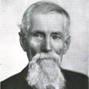 White bearded man in suit jacket and tie