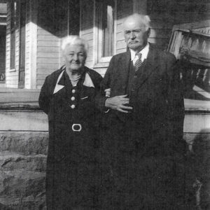 Older white man in suit and tie and older white woman in dress